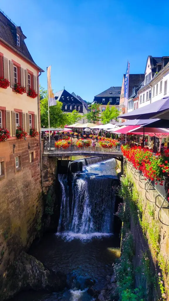 Impresionante cascada en el centro de Saarburg, Alemania, rodeada de pintorescas casas y un ambiente encantador junto al río Leuk.